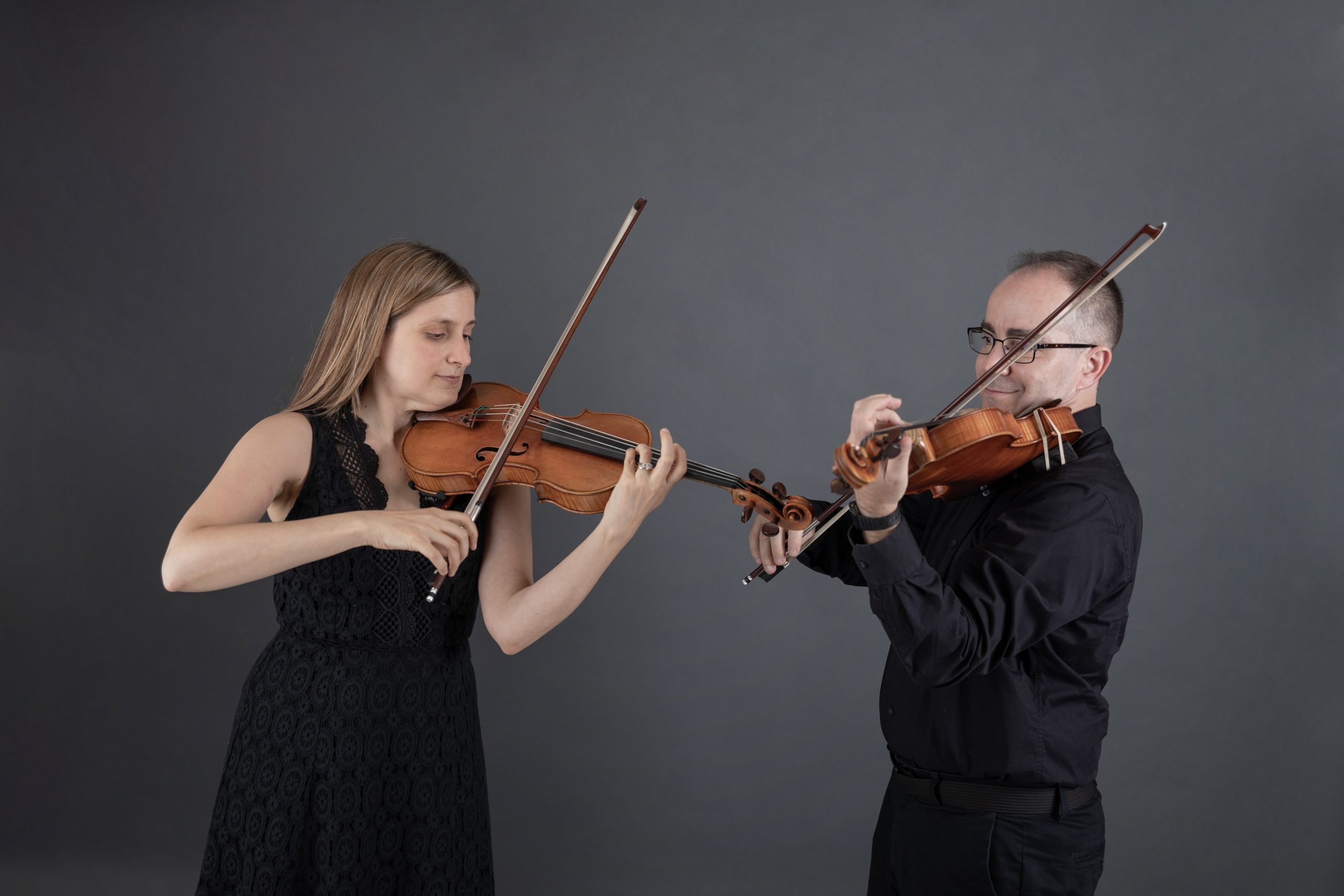 Two violinists playing together